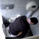 Filmed by the same person as "Voyeur Cam 1", a seemingly unsuspecting lady is observed taking a shit on the toilet from over the bathroom stall wall. Crackles & plops are clearly heard, and the poop is visible in the toilet when she gets up to wipe.